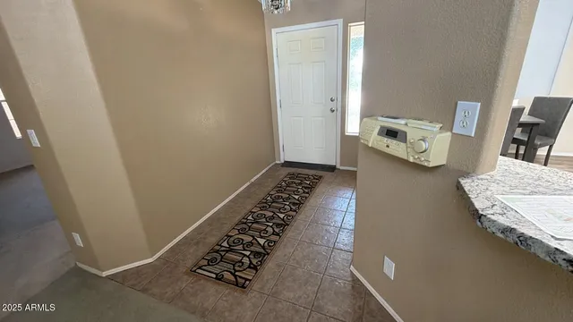 a kitchen with stainless steel appliances granite countertop a refrigerator a stove and white cabinets with wooden floor