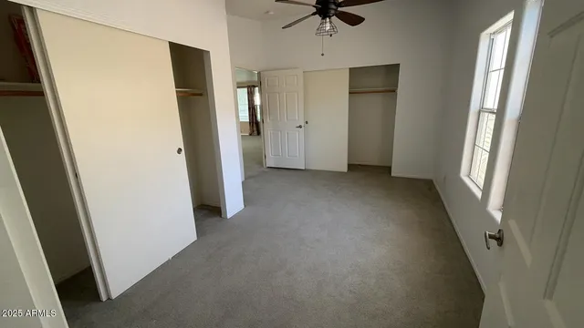 an empty room with a window and a hallway