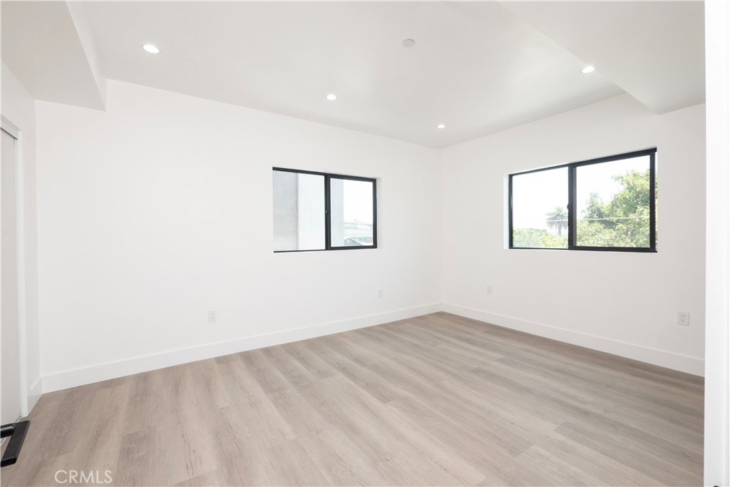 1571 Ricardo Street, Unit 2 Los Angeles, CA 90033 - Photo 12 of 29 an empty room with wooden floor and windows