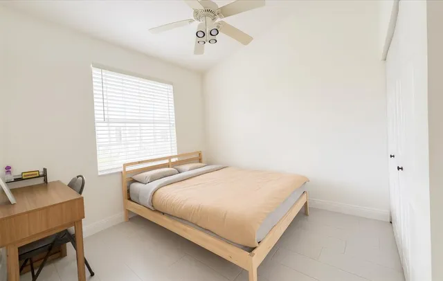 a bedroom with a bed and a desk