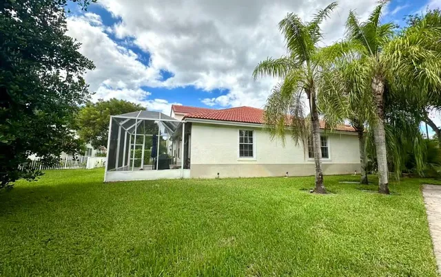 a view of a house with a yard and tree s