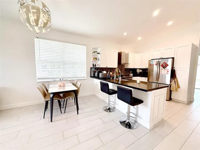 a kitchen with stainless steel appliances kitchen island granite countertop a sink and a stove