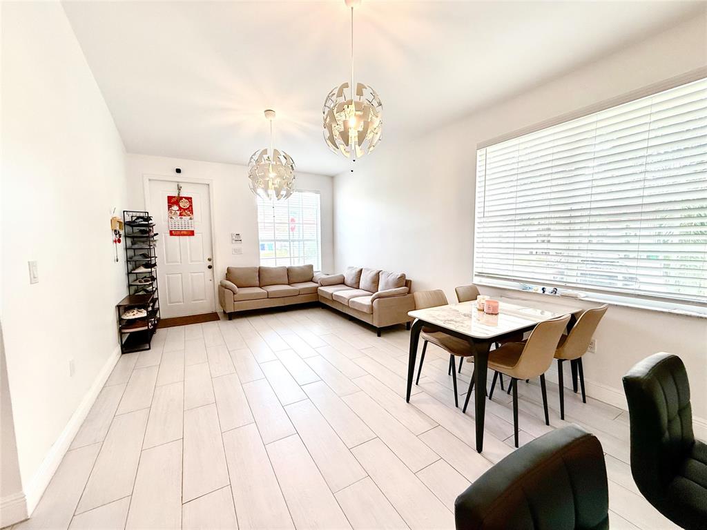 18702 Southwest 27th Street Miramar, FL 33029 - Photo 3 of 17 a bedroom with furniture and a chandelier