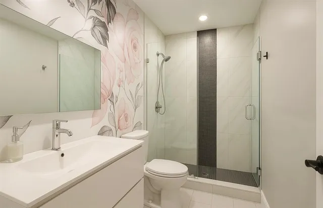 a bathroom with a sink toilet and shower