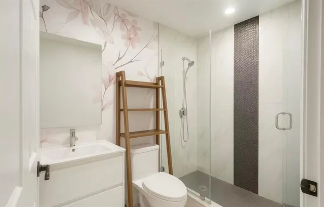 a bathroom with a sink toilet and shower