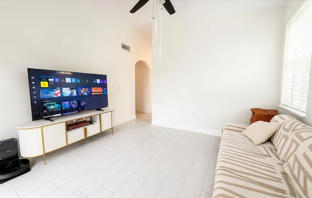 a living room with furniture and a flat screen tv