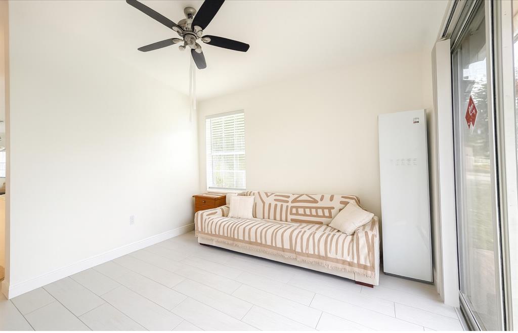 18702 Southwest 27th Street Miramar, FL 33029 - Photo 9 of 17 a bedroom with a bed and a chandelier