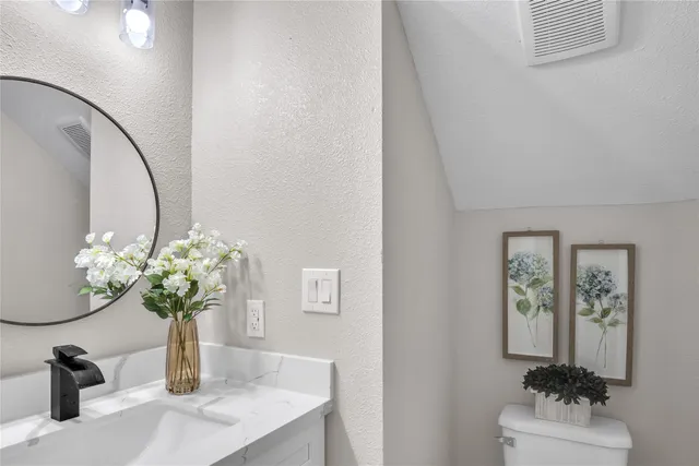 a glass vase with flowers sitting on a table