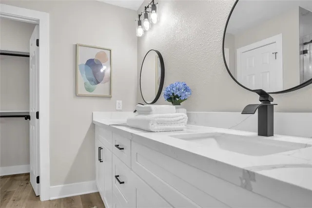 a bathroom with a sink and a mirror