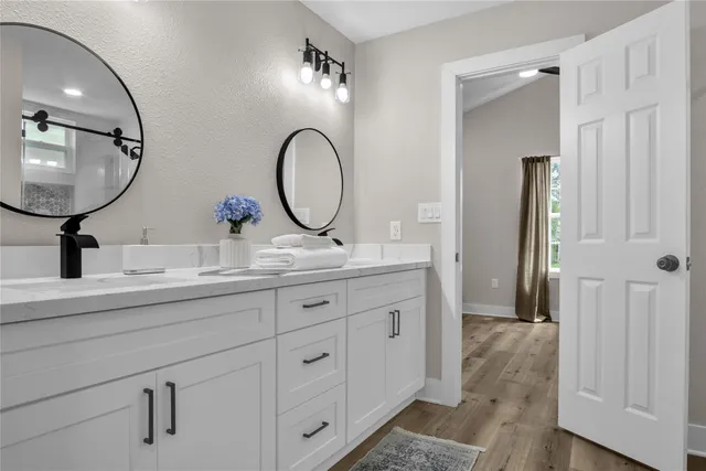 a bathroom with a double vanity sink and a mirror