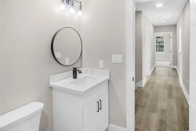 a bathroom with a sink a toilet and a mirror