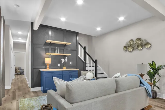 a living room with furniture and a painting