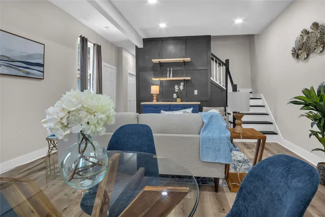 a living room with furniture and a potted plant