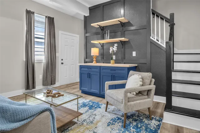 a living room with furniture and wooden floor