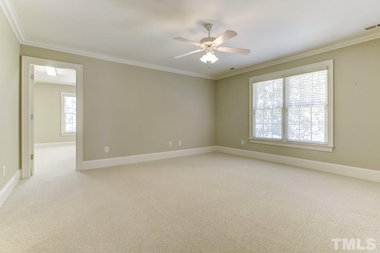 1417 Wynncrest Court Raleigh, NC 27603 - Photo 16 of 25 an empty room with windows and chandelier fan