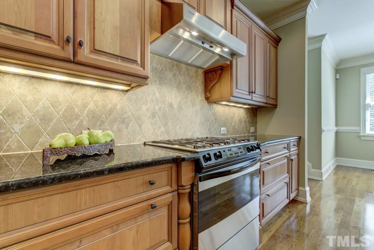 1417 Wynncrest Court Raleigh, NC 27603 - Photo 6 of 25 a kitchen with stainless steel appliances granite countertop a sink and a stove