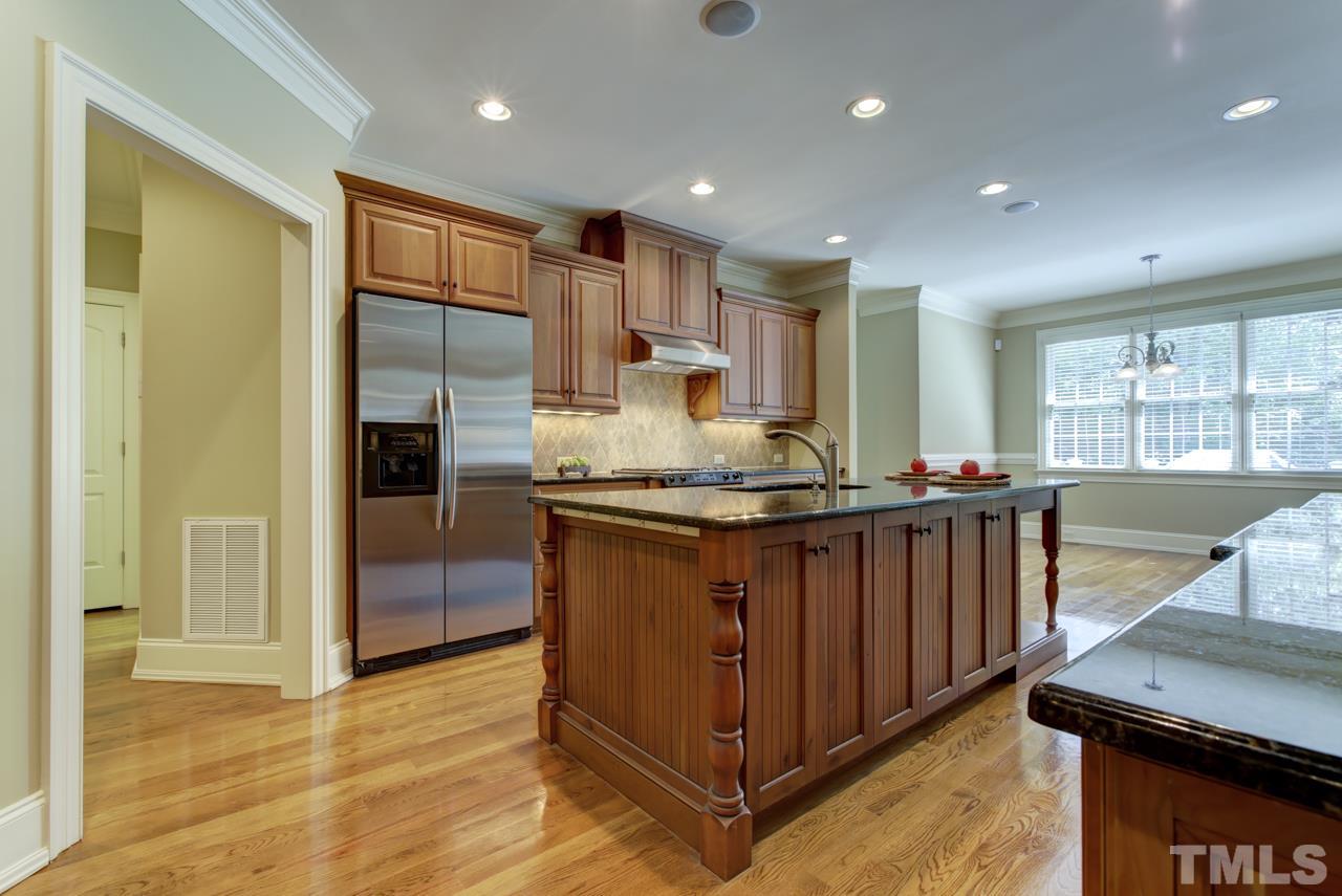 1417 Wynncrest Court Raleigh, NC 27603 - Photo 7 of 25 a kitchen with stainless steel appliances granite countertop a refrigerator and a stove top oven