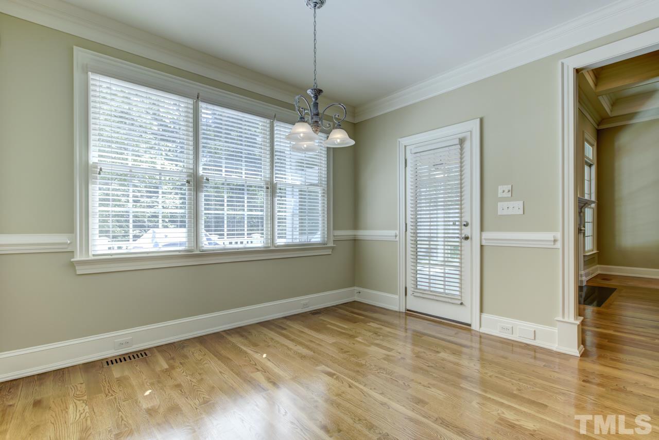 1417 Wynncrest Court Raleigh, NC 27603 - Photo 8 of 25 a view of an empty room with window and wooden floor