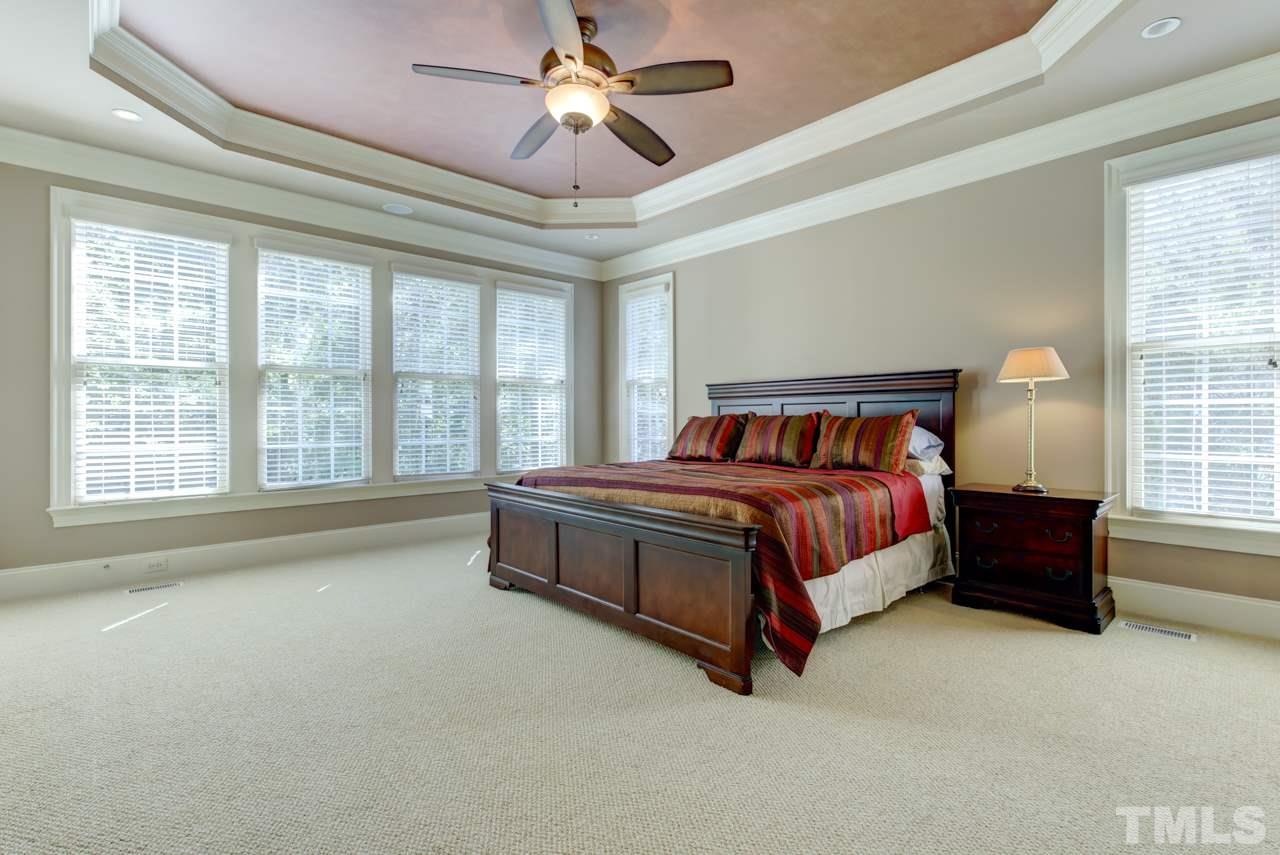 1417 Wynncrest Court Raleigh, NC 27603 - Photo 10 of 25 a spacious bedroom with a bed and a large window