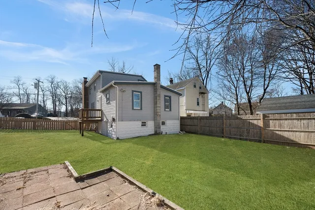 a view of a house with a yard and sitting area