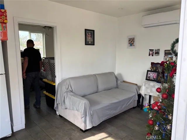 a bedroom with bed couch and window