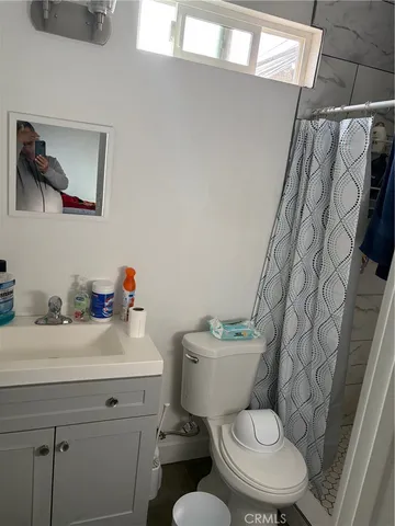 a bathroom with a toilet and a shower
