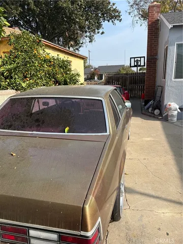 a patio with a table and chairs under an umbrella