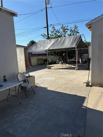 a view of a patio with table and chairs