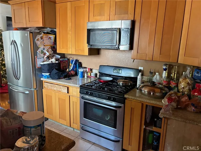 a kitchen with stainless steel appliances granite countertop a stove and a refrigerator