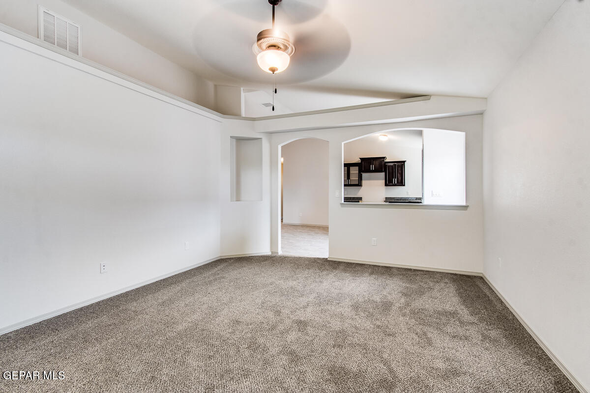 12420 Oconee Place Clint, TX 79836 - Photo 7 of 27 en empty room with a fireplace and wooden floor