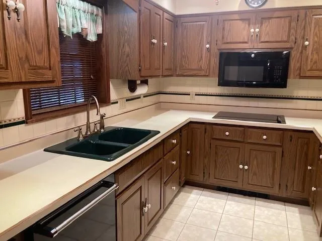 a kitchen with stainless steel appliances granite countertop a refrigerator and a stove