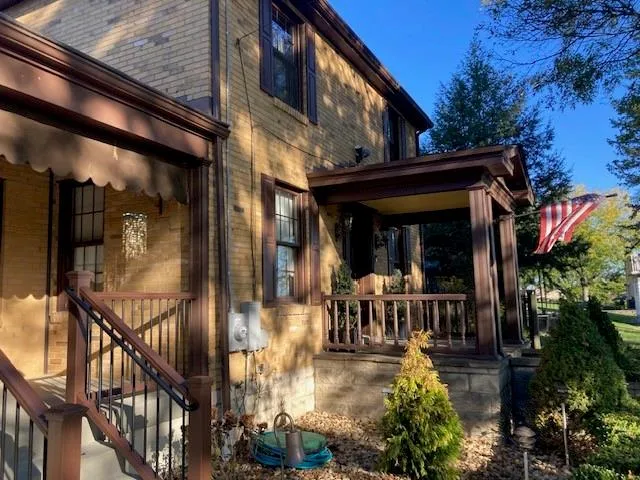 a view of a house with wooden floor and wooden fence
