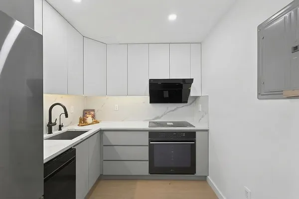 a kitchen with stainless steel appliances a sink stove and microwave
