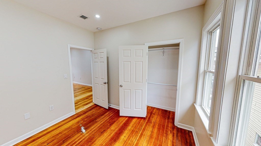 109 Deering Road, Unit 1 Boston, MA 02126 - Photo 10 of 12 a view of a room with wooden floor and staircase