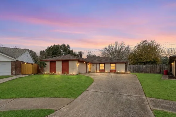 a front view of house with yard and green space