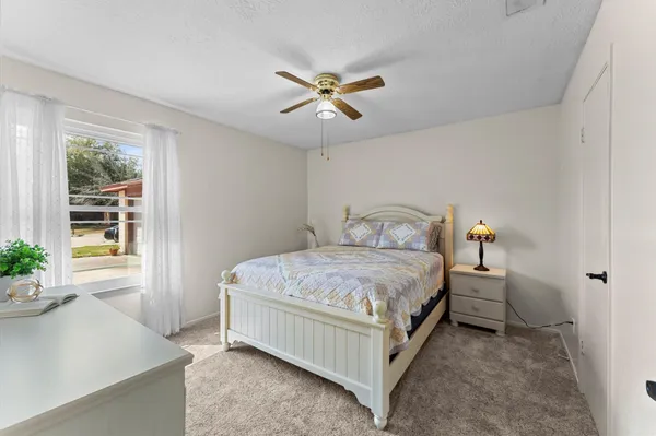 a bedroom with a bed and window