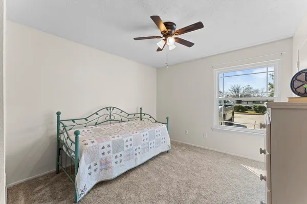 a bedroom with a bed a window and closet