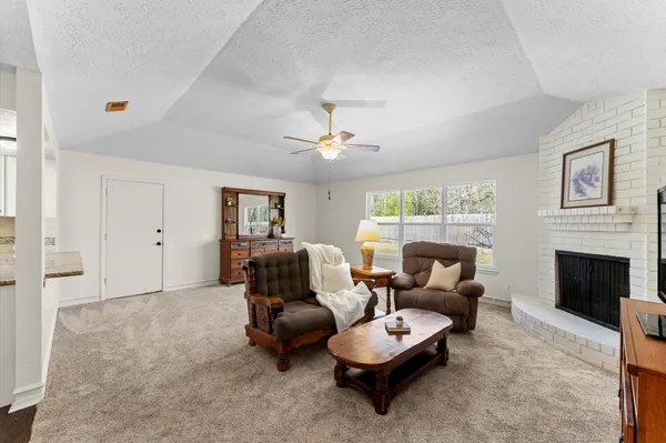 a living room with furniture and a fireplace