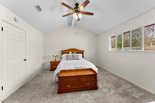 a bedroom with a bed and window