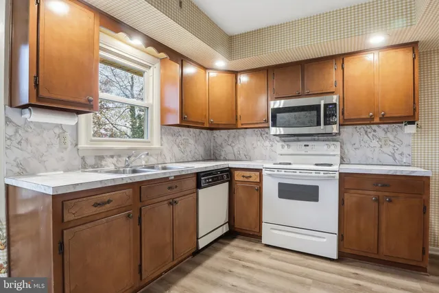 a kitchen with a sink stove and microwave