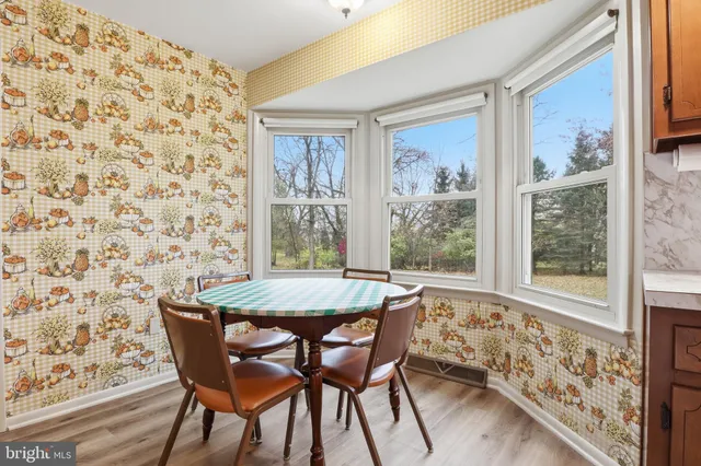 a dining room with furniture and wooden floor