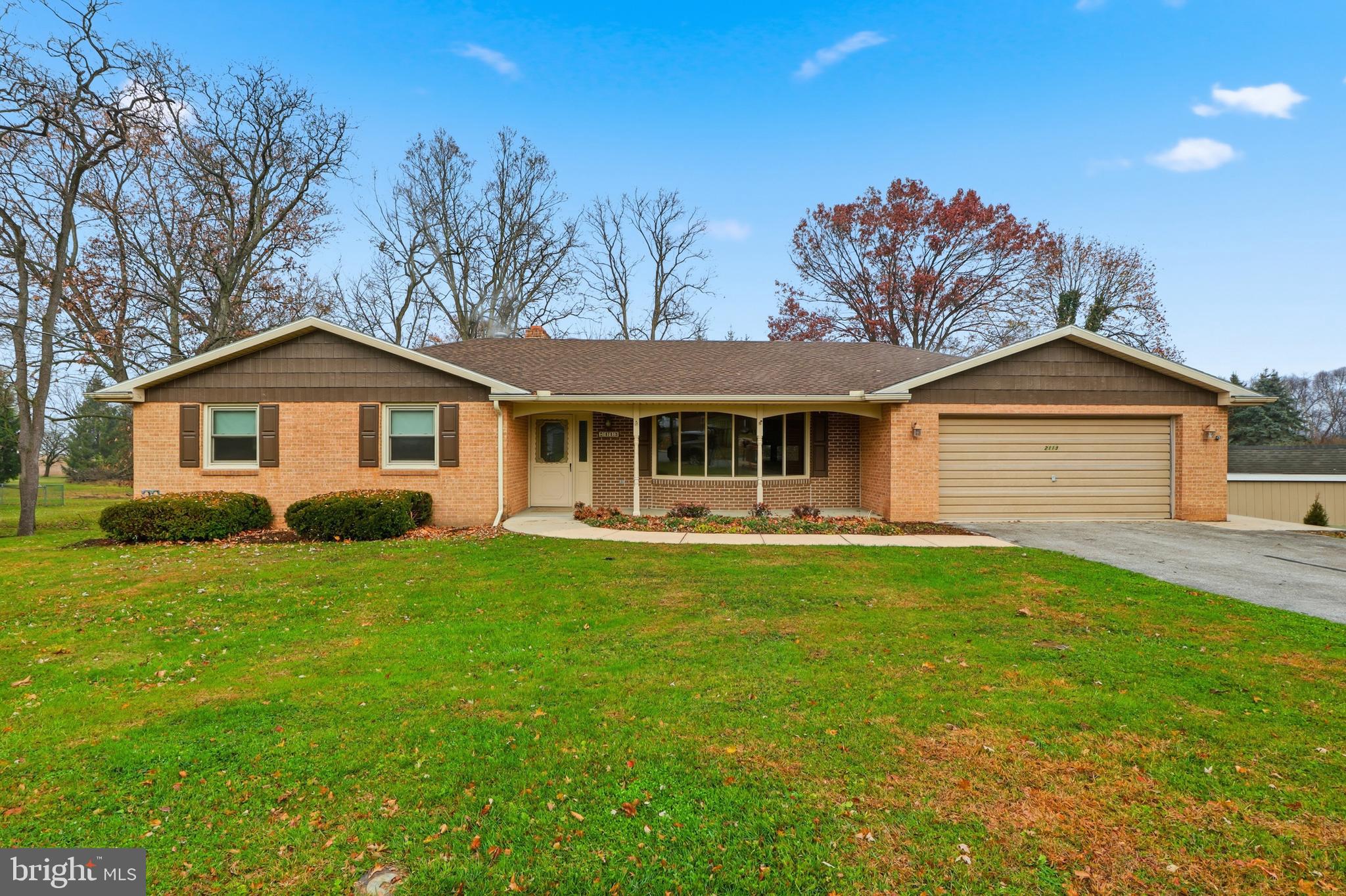 2113 Huntington Road Dover, PA 17315 - Photo 2 of 50 a front view of a house with a garden