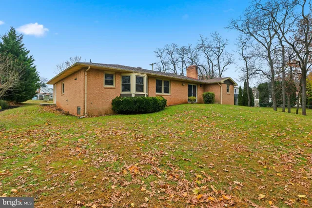 a front view of a house with yard and green space