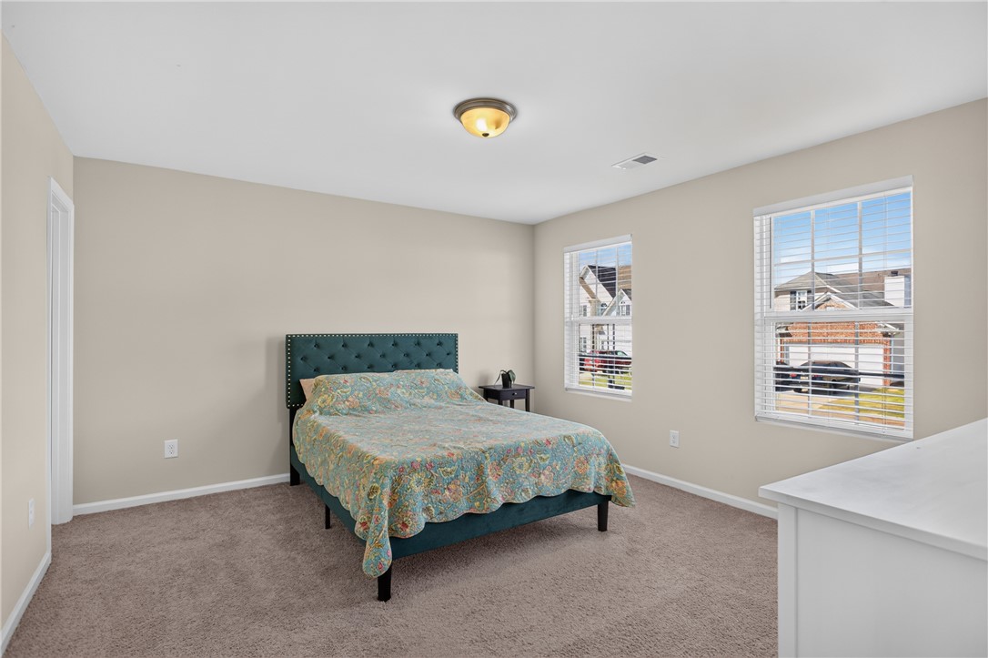 1081 Edenbrooke Circle Anderson, SC 29621 - Photo 33 of 46 Comfortable bedroom with plush carpeting and natural light from twin windows.