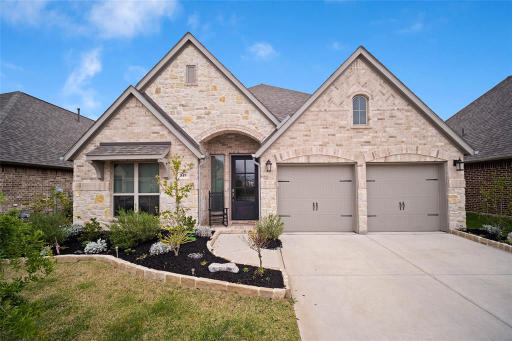 a front view of a house with a yard and garage