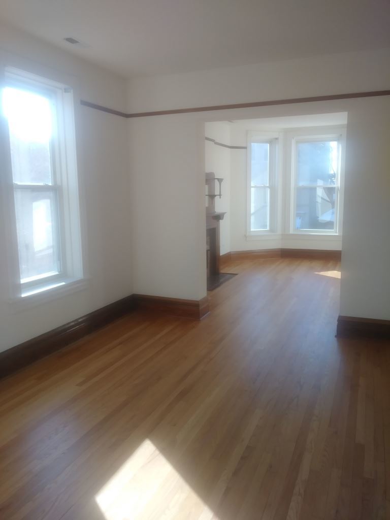 3013 South Wells Street, Unit 2 Chicago, IL 60616 - Photo 2 of 13 wooden floor in an empty room with a window