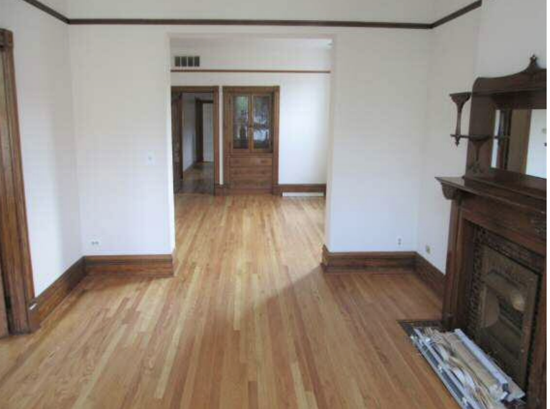 3013 South Wells Street, Unit 2 Chicago, IL 60616 - Photo 9 of 13 wooden floor in an empty room with a fireplace