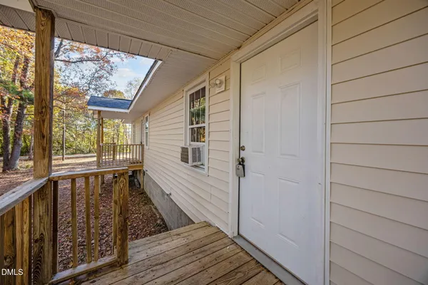 a view of a house with a yard and wooden fence