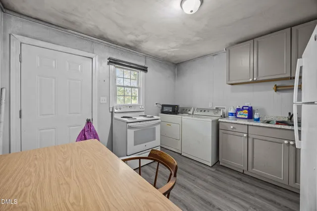 a utility room with cabinets washer and dryer