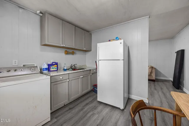 a view of a room with wooden floor and windows